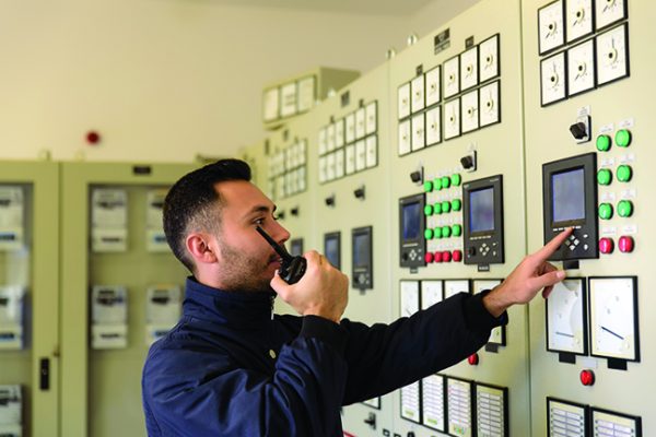 Man in front of control panel